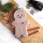 gingerbread man shaped bottle of homemade irish cream near Christmas decor