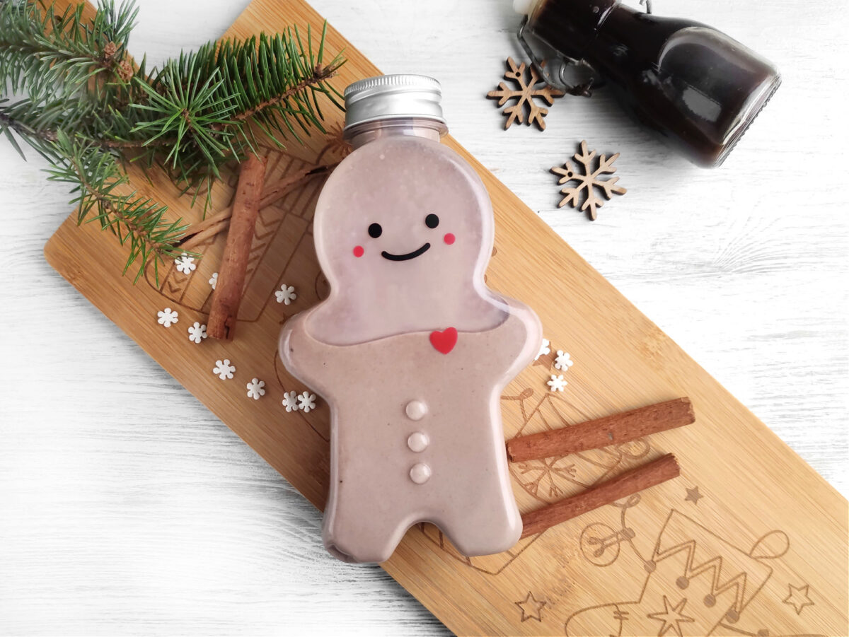 gingerbread man shaped bottle of homemade irish cream near Christmas decor