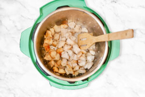 top view of coated chicken in an instant pot