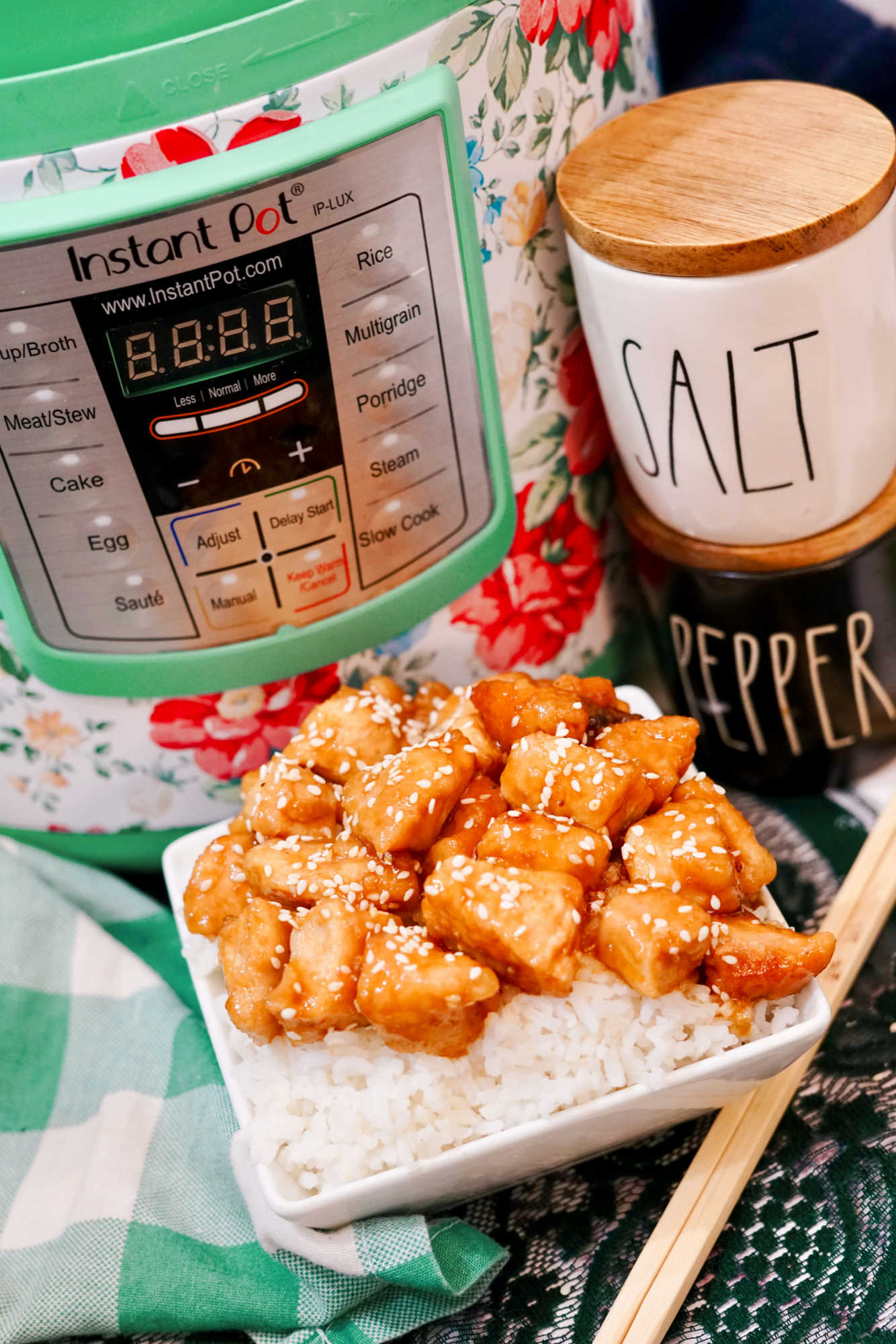 a plated serving of firecracker chicken near an instant pot