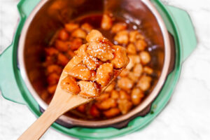 wooden spoon of a scoop of firecracker chicken